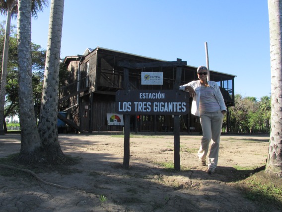 Sonia Delphin-Perez standing next to a sign that reads Estacion Los Tres Gigantes