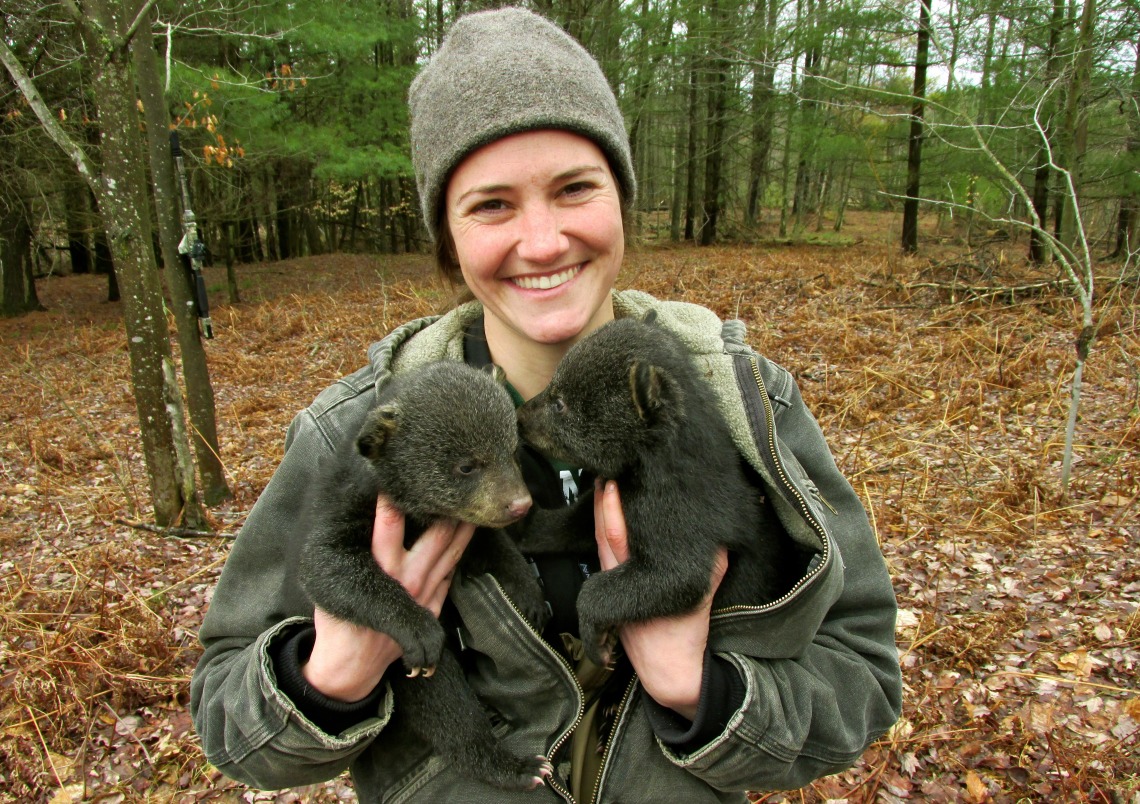 Jennifer Smith holding two bear cubs.